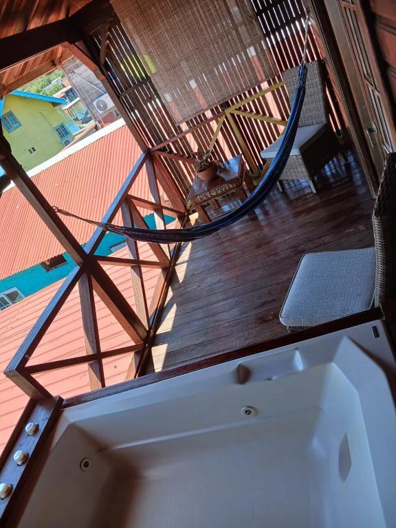 Looking down onto the King Room terrace: the hot tub, a hammock slung across the deck and a chair.