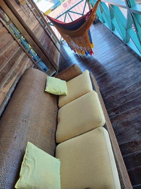 The suite's terrace: a wicker sofa with cushions and a striped hammock strung across the deck.
